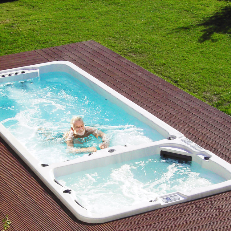 an old man swimming in dual chamber swim spa