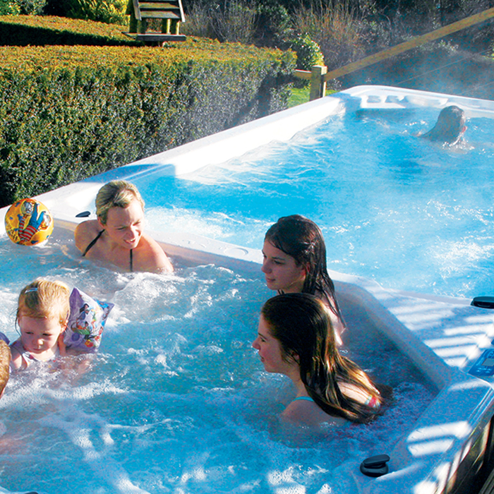 family in dual chamber swim spa